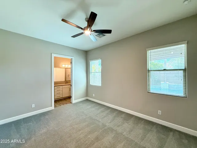 a view of a livingroom with a ceiling fan and window