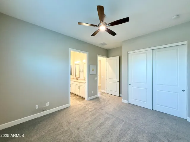 a view of an empty room and a ceiling fan