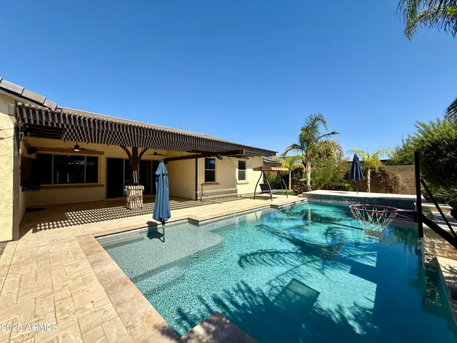 a swimming pool with outdoor seating and yard