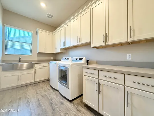 a kitchen with white cabinets and white appliances