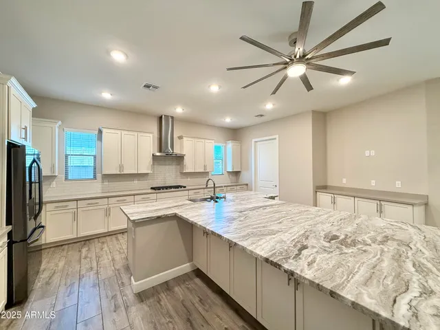 a kitchen with stainless steel appliances granite countertop a sink and cabinets
