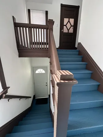 a view of entryway with stairs and wooden floor