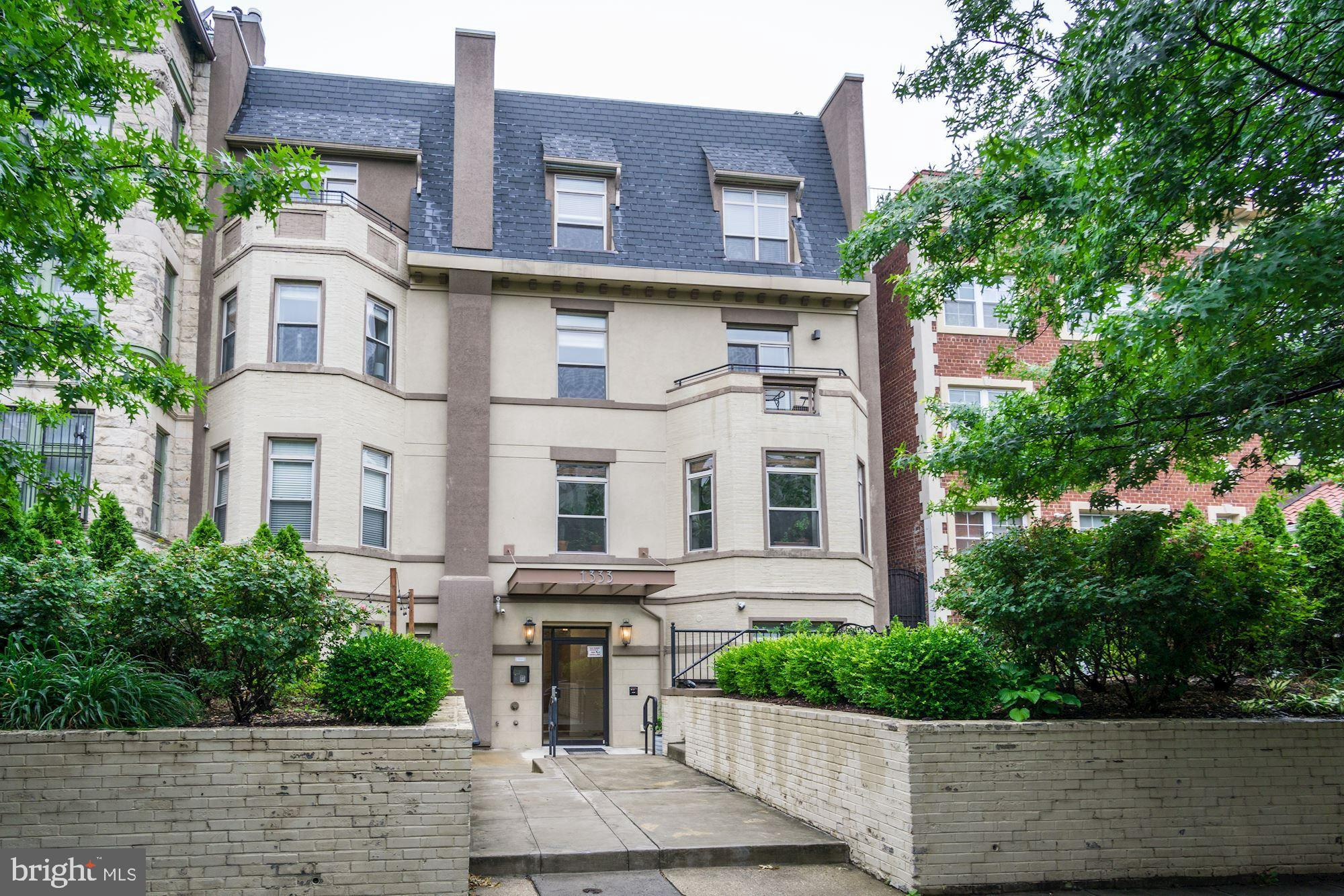 1333 Euclid Street Northwest, Unit 202 Washington, DC 20009 - Photo 1 of 14 a front view of a residential houses with yard
