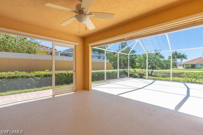 7640 Rozzini Lane Naples, FL 34114 - Photo 12 of 12 a view of a house with a large window and wooden fence