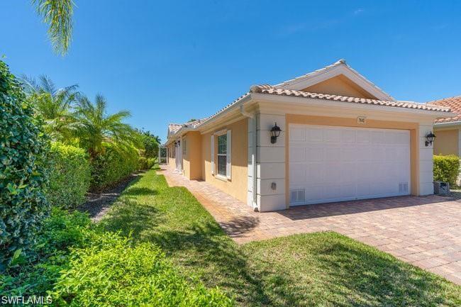 7640 Rozzini Lane Naples, FL 34114 - Photo 2 of 12 a view of a house with a small yard