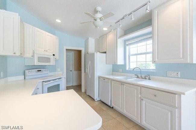 7640 Rozzini Lane Naples, FL 34114 - Photo 3 of 12 a kitchen with a sink stove and refrigerator