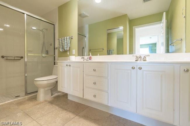 7640 Rozzini Lane Naples, FL 34114 - Photo 8 of 12 a spacious bathroom with a granite countertop sink a toilet and a mirror