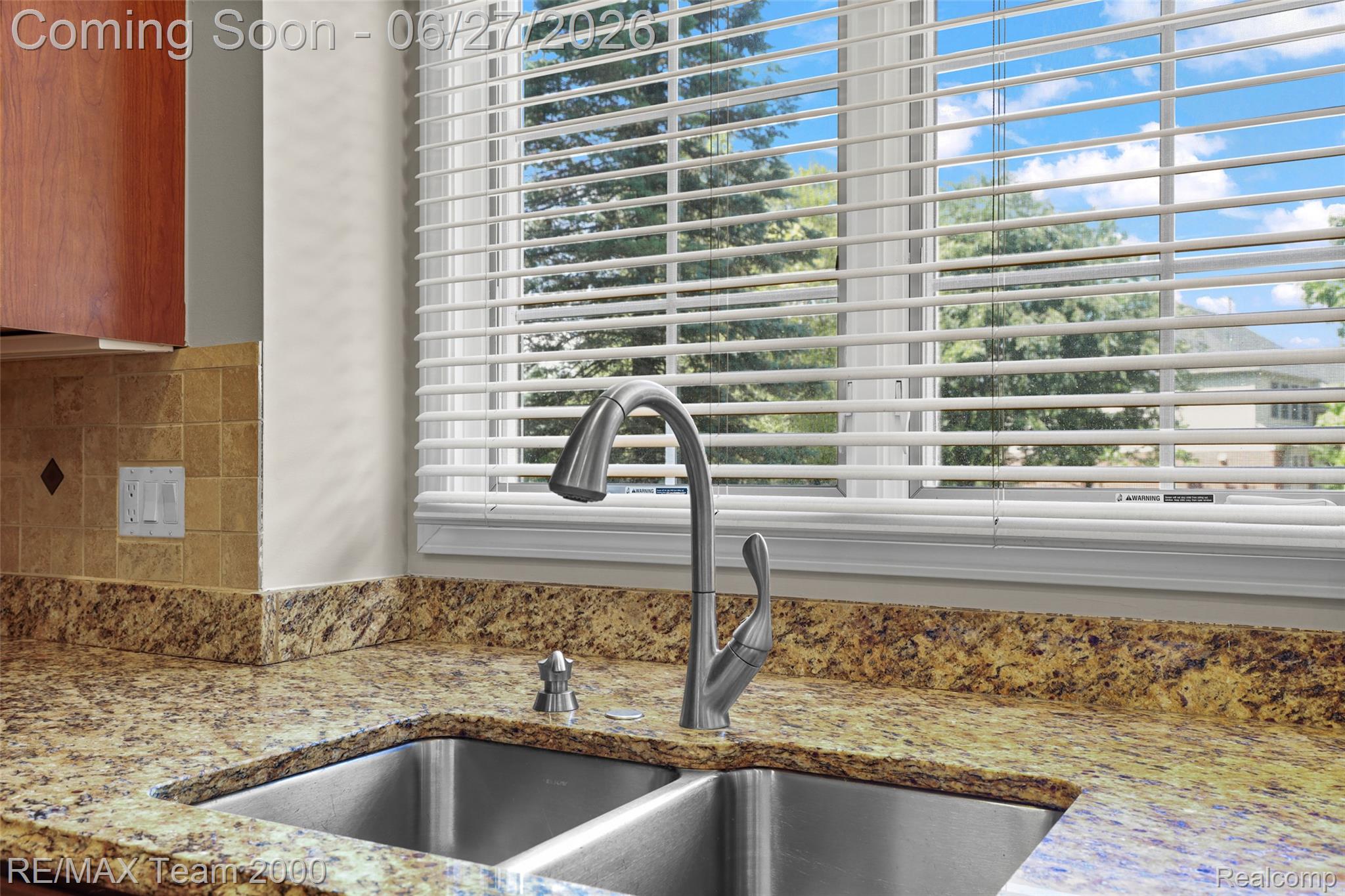 1248 Lasalle Road Canton, MI 48187 - Photo 32 of 67 Double basin stainless steel sink with a high-arc faucet, set into a speckled granite countertop