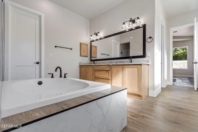 a spacious bathroom with a sink and a large mirror