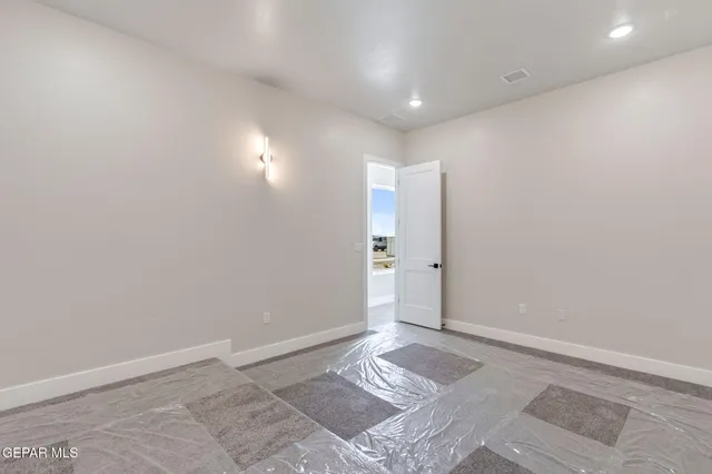 a view of a room with wooden floor