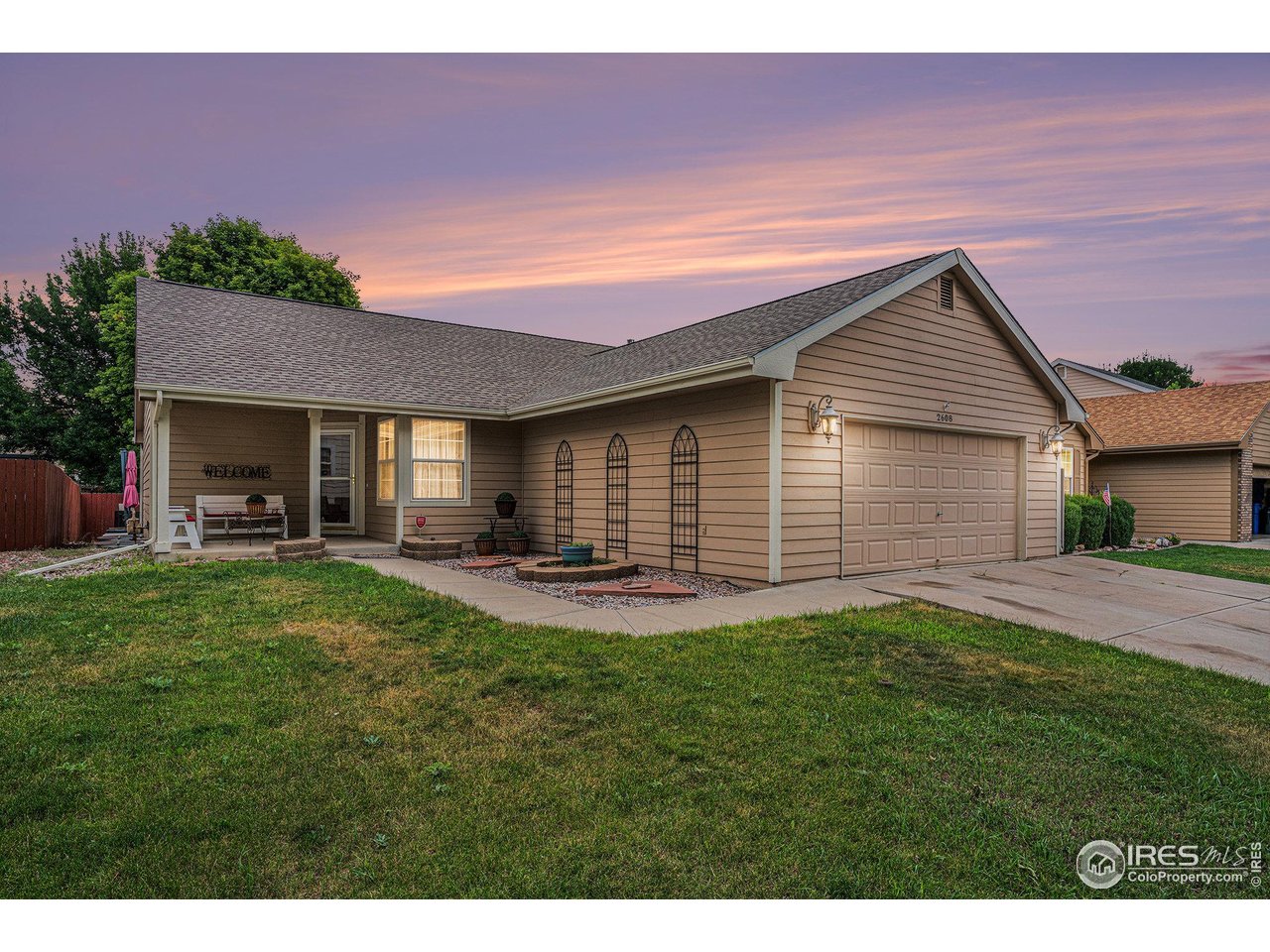 a backyard of a house with table and chairs