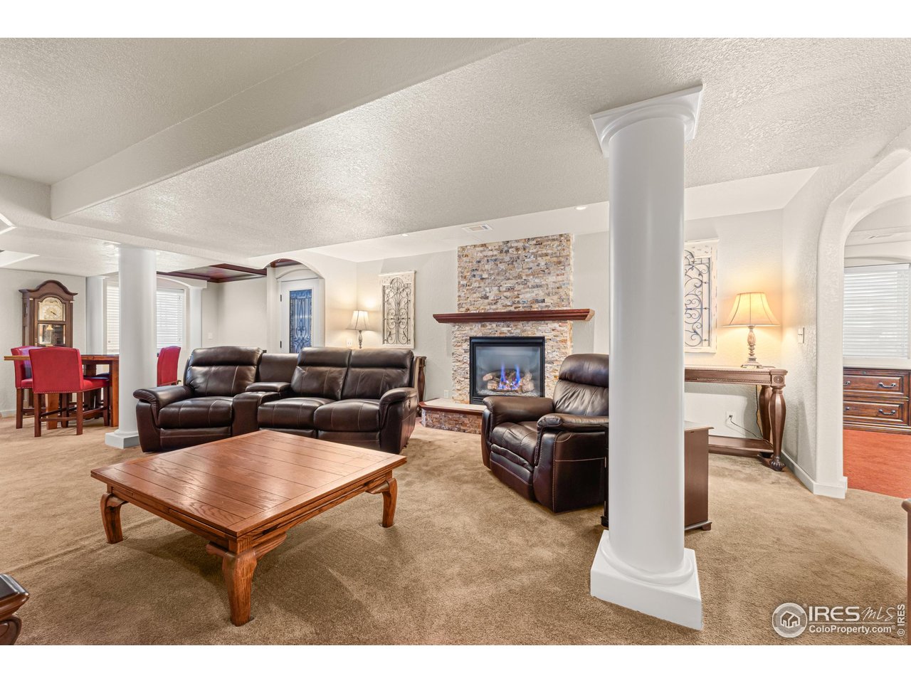 2608 Paddington Road Fort Collins, CO 80525 - Photo 25 of 37 pillars and archways accentuate the taller ceilings in the basement