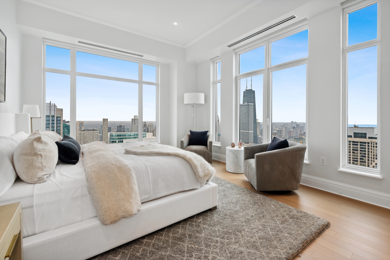 451 East Grand Avenue, Unit 5909 Chicago, IL 60611 - Photo 16 of 38 a bedroom with a large bed and a couch