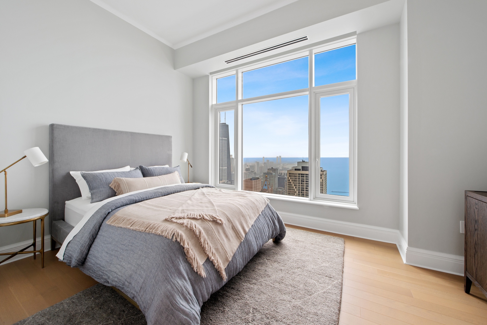 451 East Grand Avenue, Unit 5909 Chicago, IL 60611 - Photo 21 of 38 a large bed sitting in a bedroom next to a window