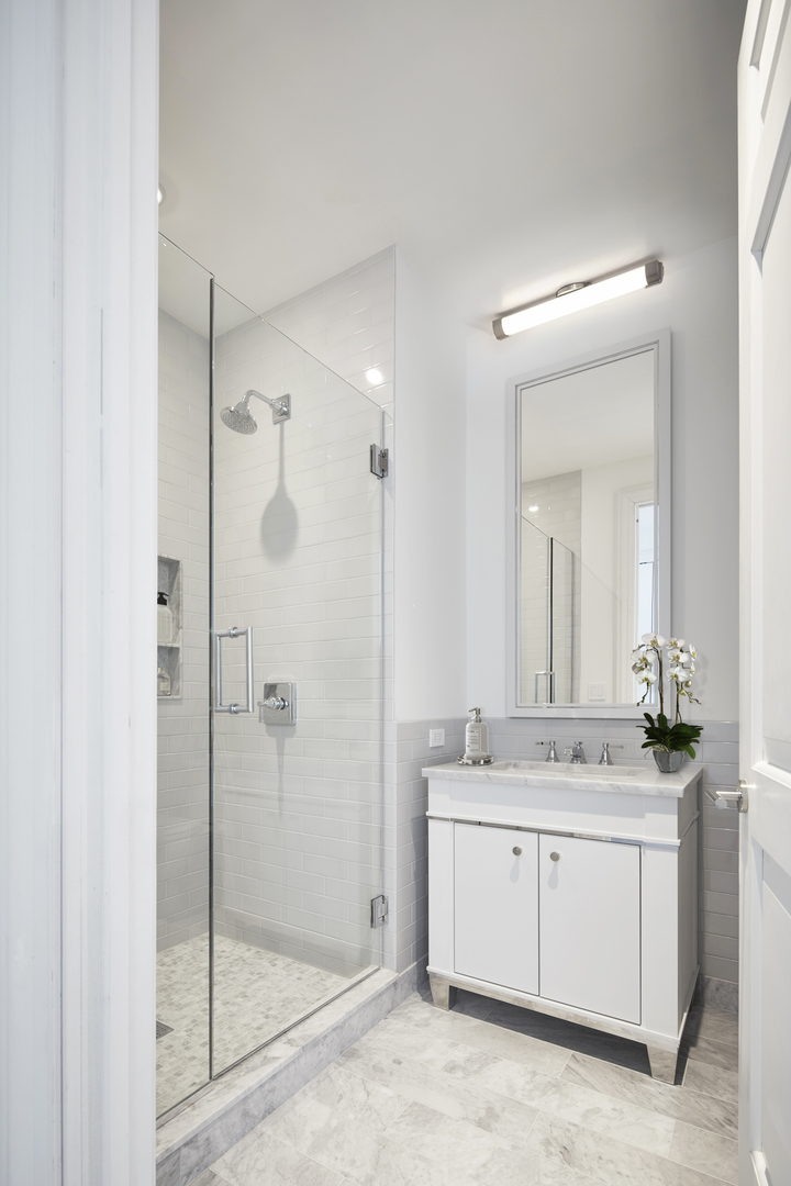 451 East Grand Avenue, Unit 5909 Chicago, IL 60611 - Photo 22 of 38 a bathroom with a shower sink and mirror