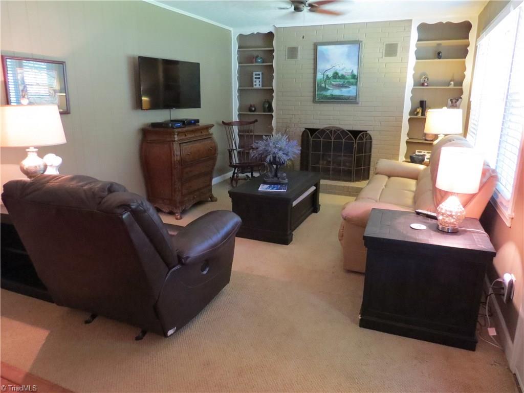 2881 Swallow Road Reidsville, NC 27320 - Photo 7 of 16 Living room with built in book cases and fireplace with Gas logs