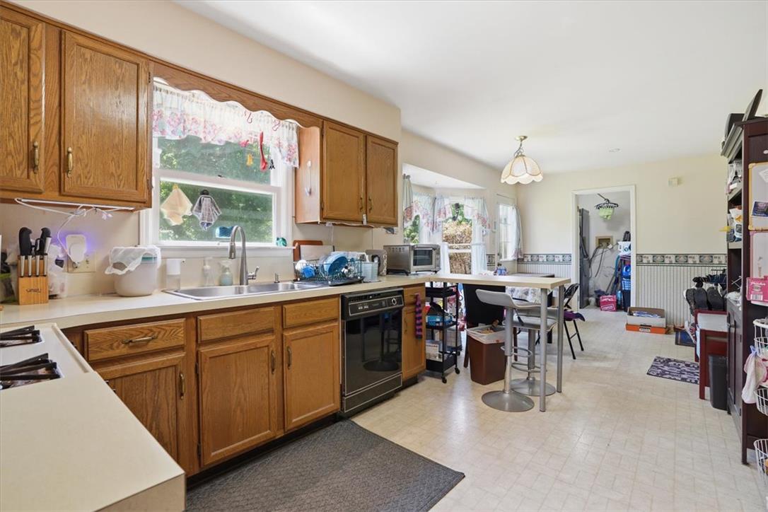 808 Hunter Road Easton, PA 18040 - Photo 14 of 41 Bright and functional, this kitchen features a practical layout with ample wooden cabinetry and a convenient eat-in bar area.