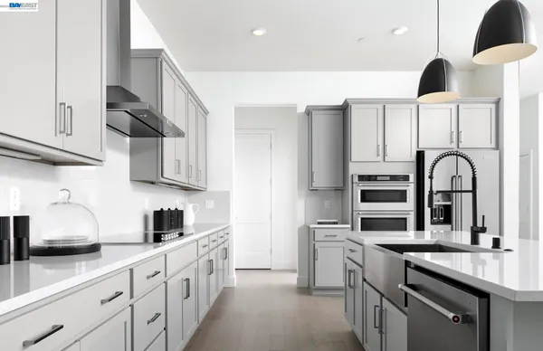 a kitchen with stainless steel appliances a sink stove and cabinets