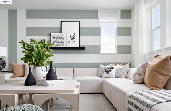 a living room with furniture and potted plant