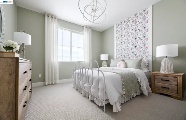 a spacious bedroom with a bed and a chandelier