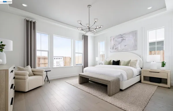 a spacious bedroom with a bed and a couch