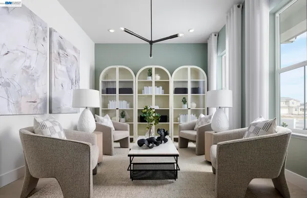 a spacious bedroom with furniture and a large window