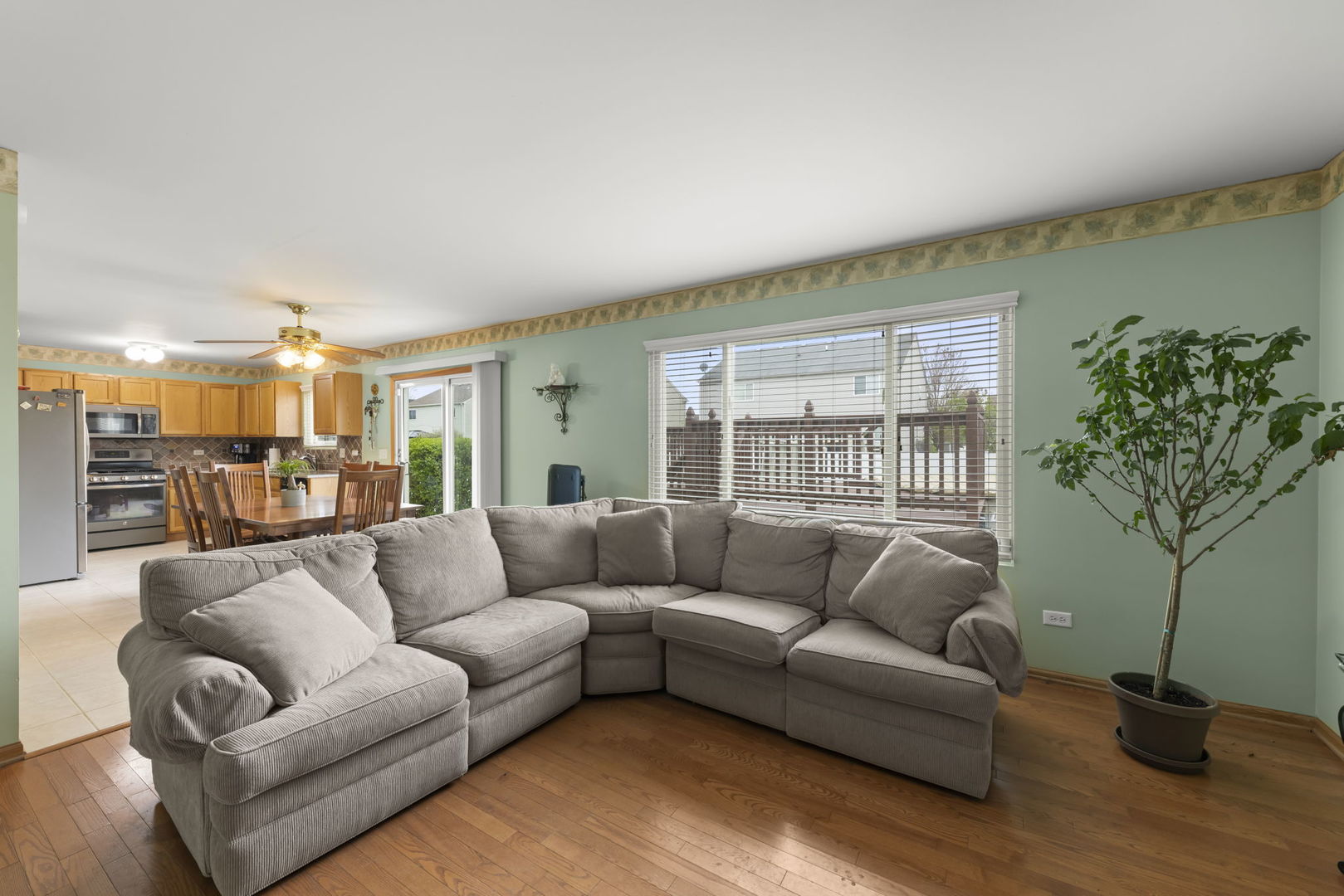 2217 Cedar Ridge Drive Plainfield, IL 60586 - Photo 11 of 26 a living room with furniture a couch and a potted plant