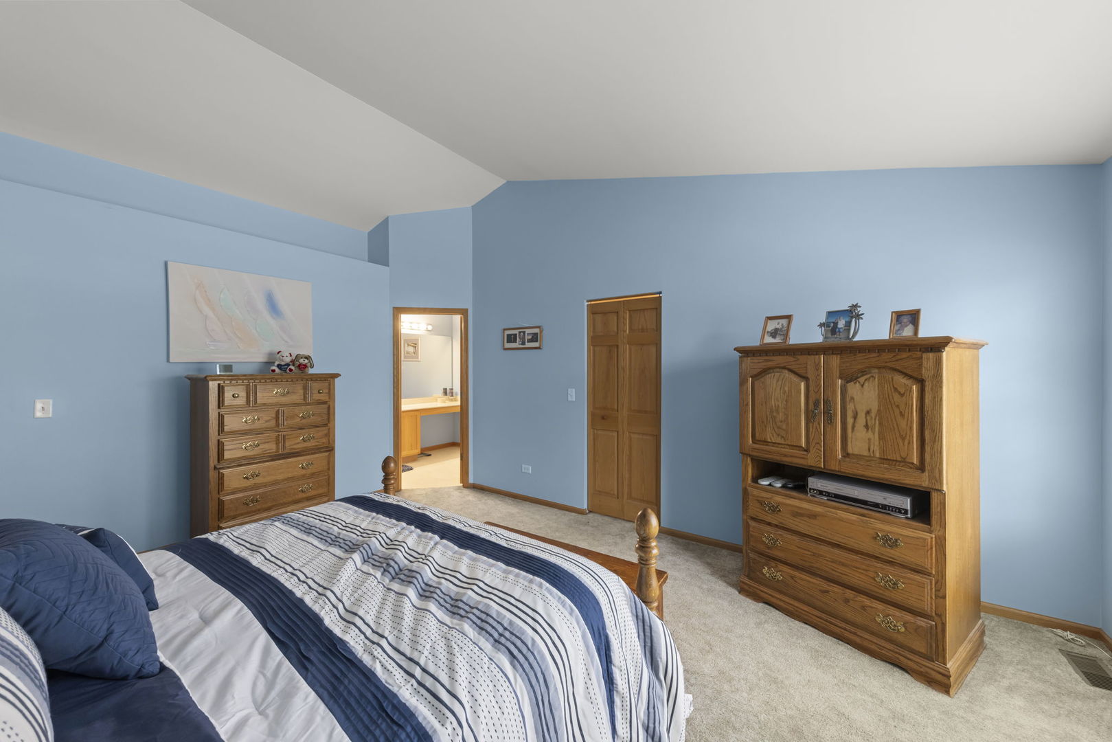 2217 Cedar Ridge Drive Plainfield, IL 60586 - Photo 15 of 26 a bedroom with a bed and a dresser in it