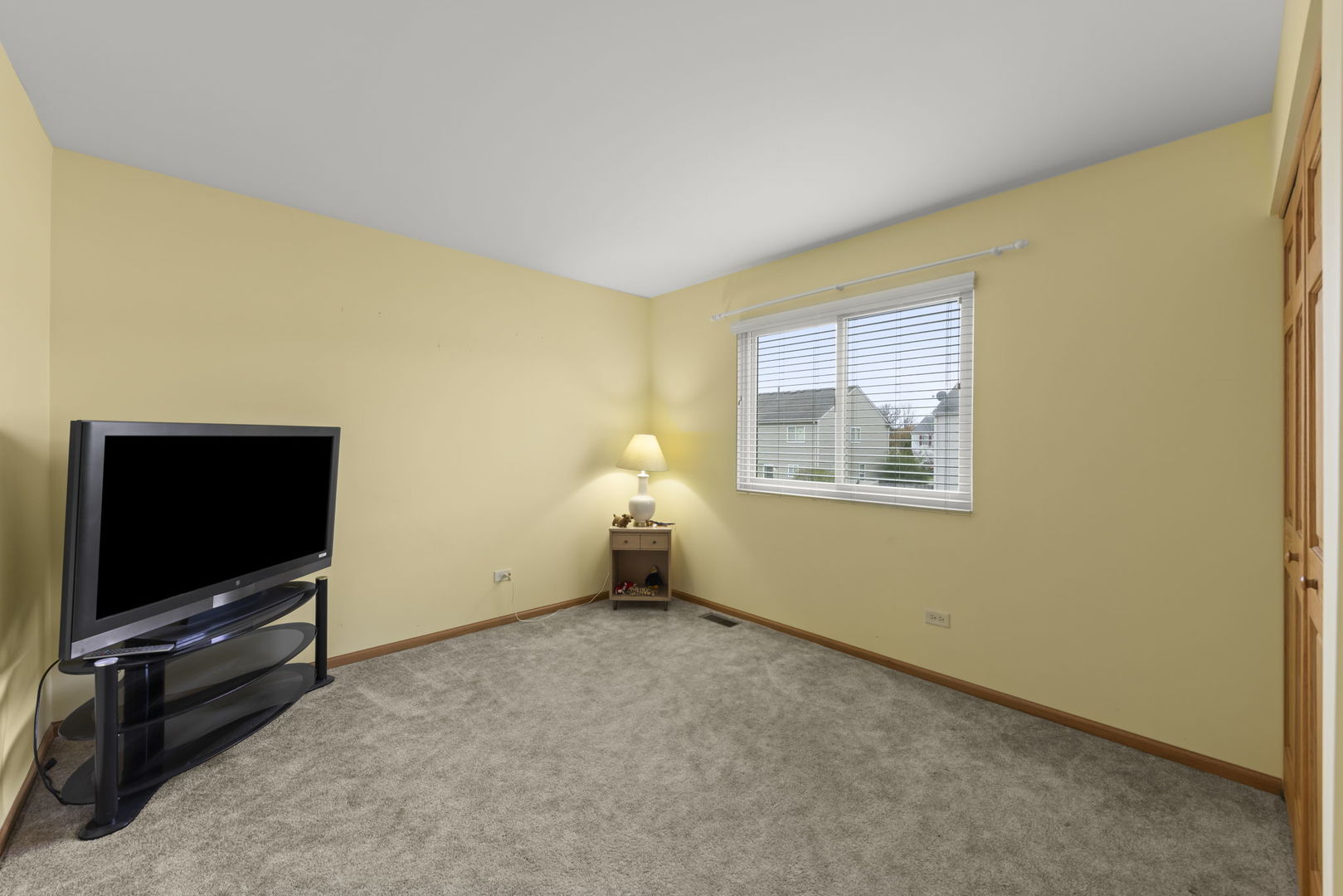 2217 Cedar Ridge Drive Plainfield, IL 60586 - Photo 18 of 26 a living room with a flat screen tv and a window