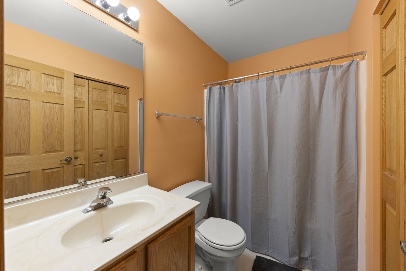 2217 Cedar Ridge Drive Plainfield, IL 60586 - Photo 20 of 26 a bathroom with a sink a toilet and shower curtain