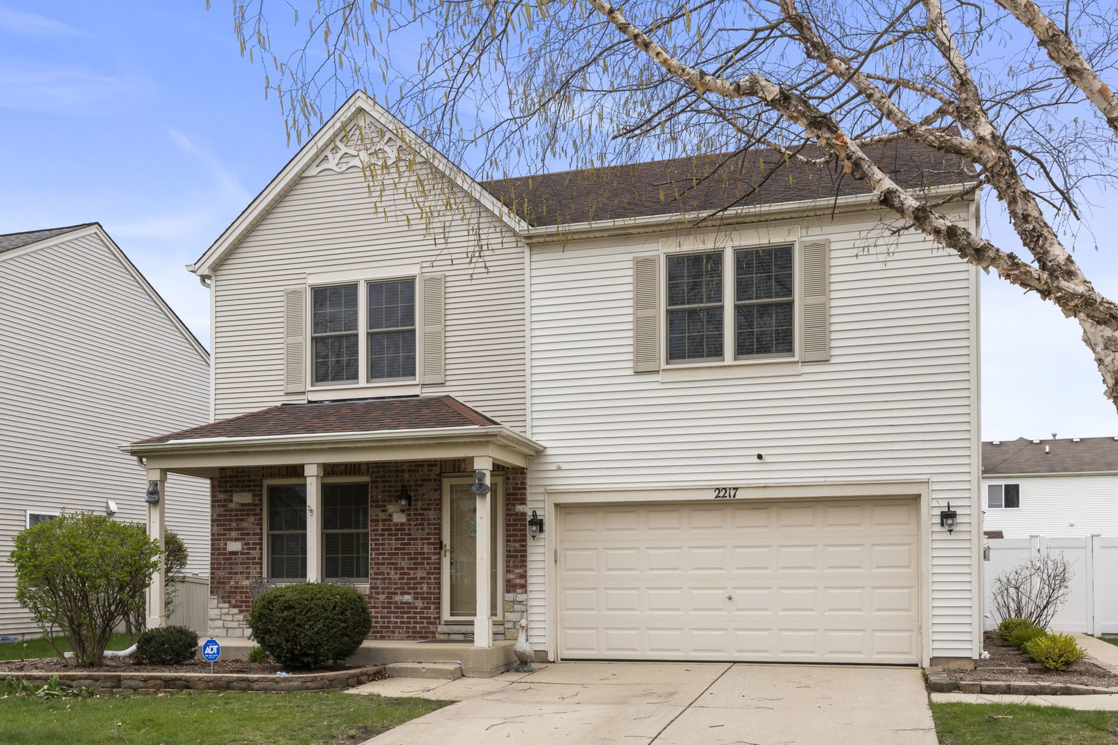 2217 Cedar Ridge Drive Plainfield, IL 60586 - Photo 26 of 26 a view of a white house with large windows and a yard with stairs