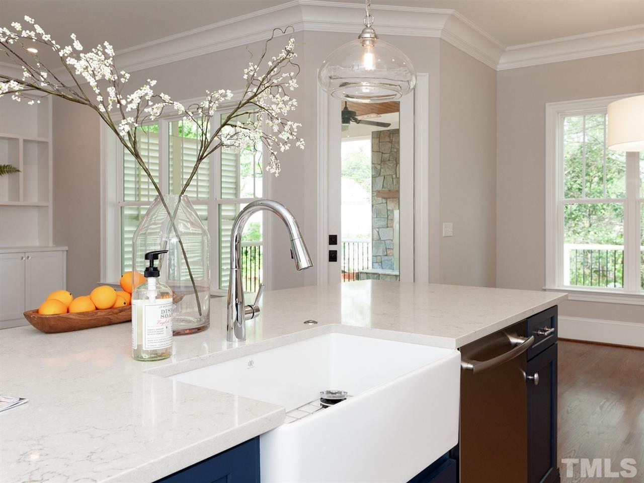 2804 Oberry Street Raleigh, NC 27607 - Photo 12 of 25 a kitchen with a sink and a chandelier
