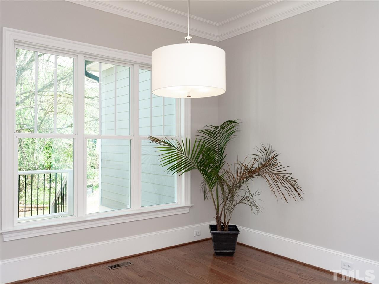 2804 Oberry Street Raleigh, NC 27607 - Photo 14 of 25 a view of a room with a large window and wooden floor