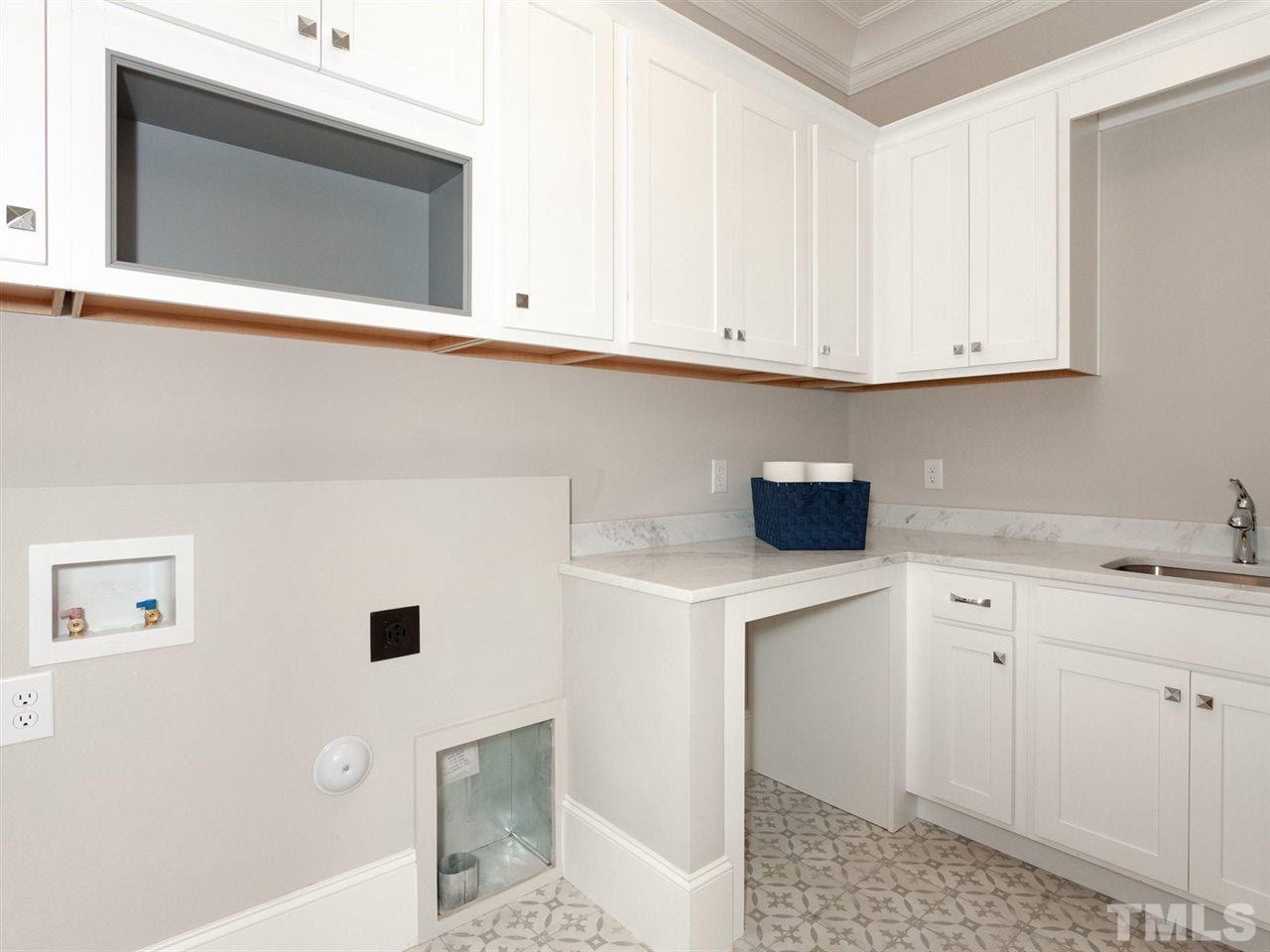 2804 Oberry Street Raleigh, NC 27607 - Photo 16 of 25 a kitchen with stainless steel appliances white cabinets and a window