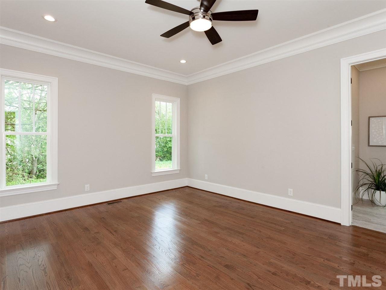 2804 Oberry Street Raleigh, NC 27607 - Photo 17 of 25 a view of an empty room with wooden floor and a window