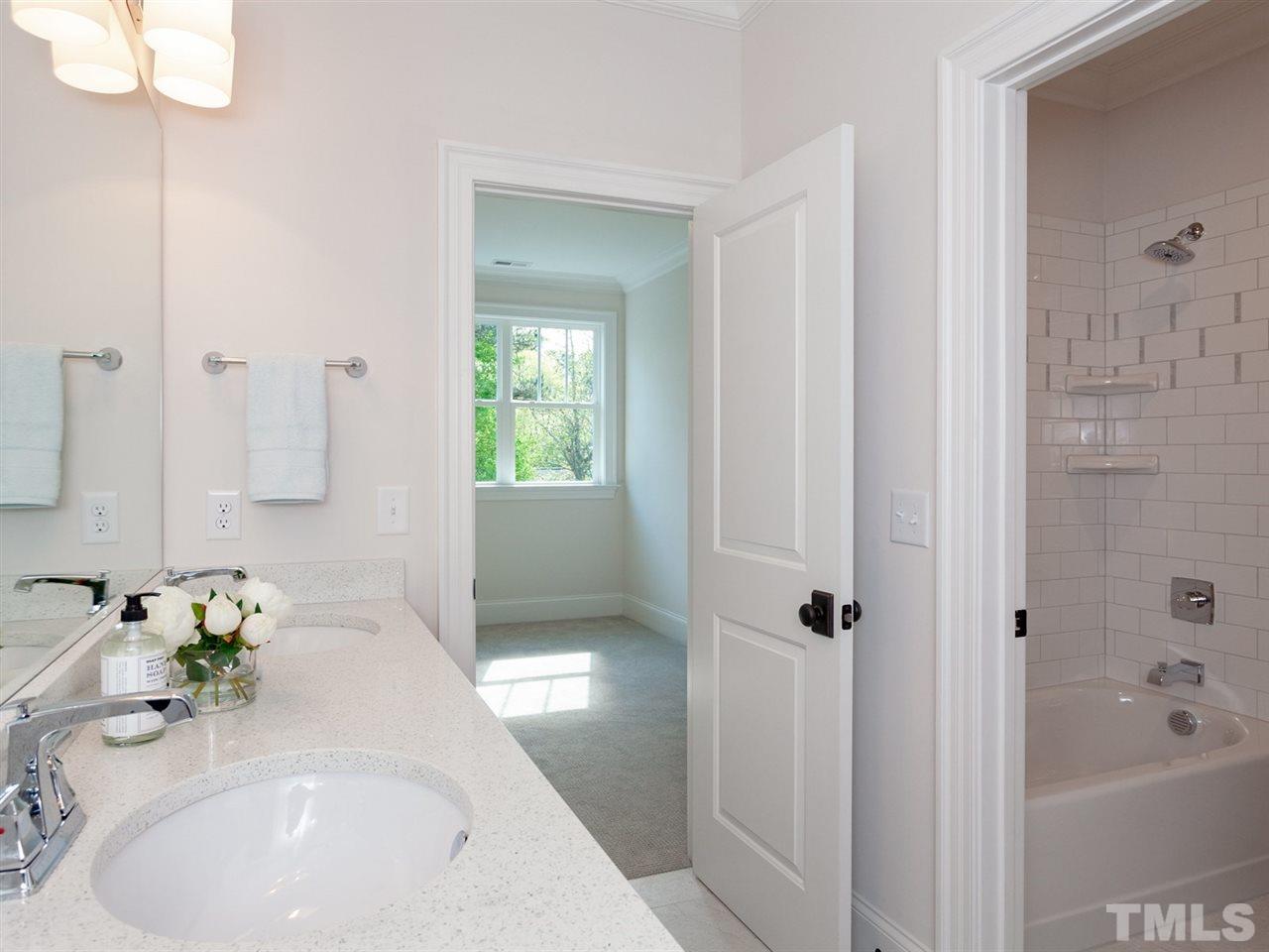 2804 Oberry Street Raleigh, NC 27607 - Photo 22 of 25 a bathroom with a tub sink and mirror