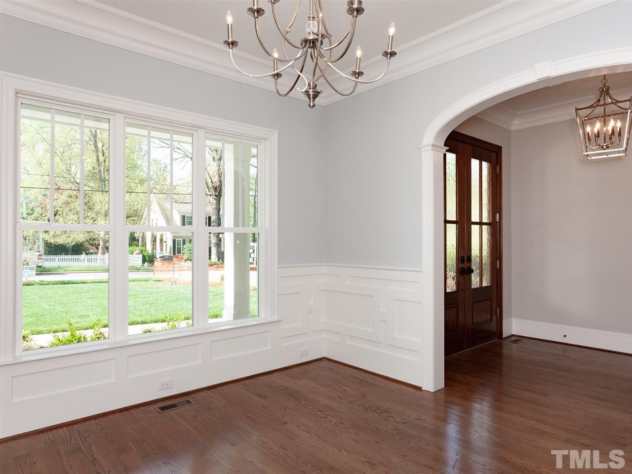 2804 Oberry Street Raleigh, NC 27607 - Photo 4 of 25 a view of an empty room with wooden floor and a window