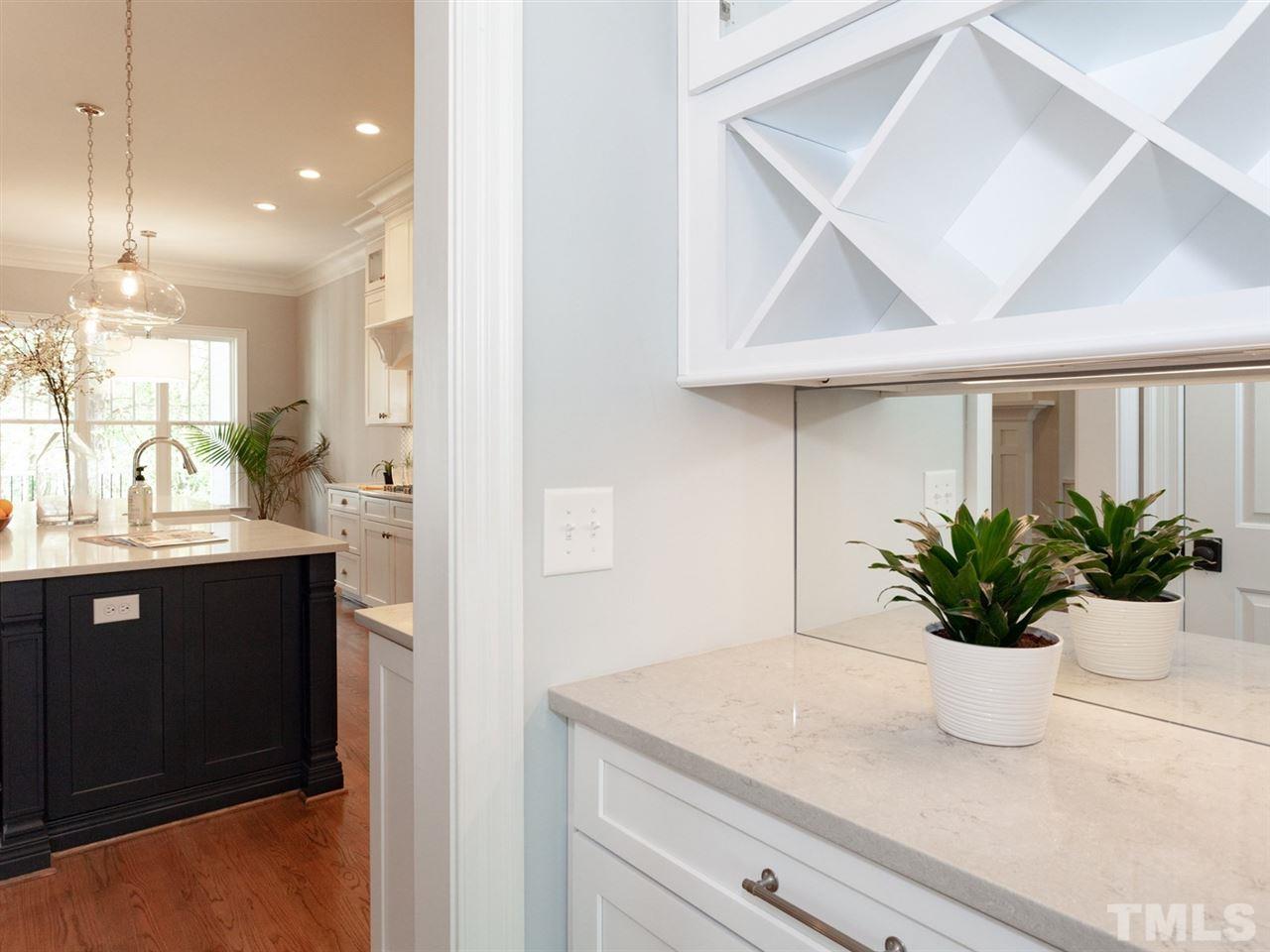 2804 Oberry Street Raleigh, NC 27607 - Photo 5 of 25 a bathroom with a sink a mirror and a potted plant
