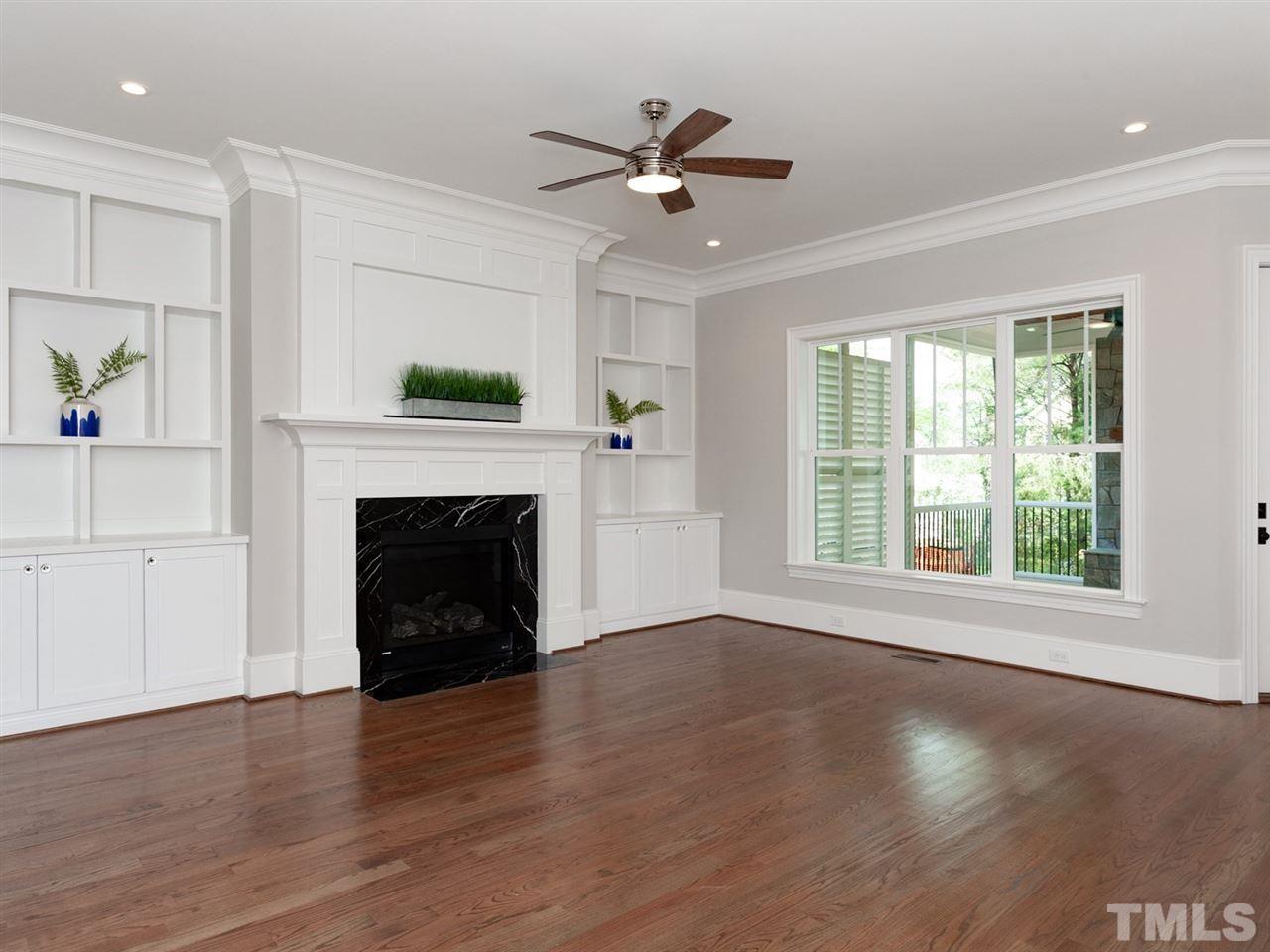 2804 Oberry Street Raleigh, NC 27607 - Photo 7 of 25 a view of an empty room with wooden floor and a window