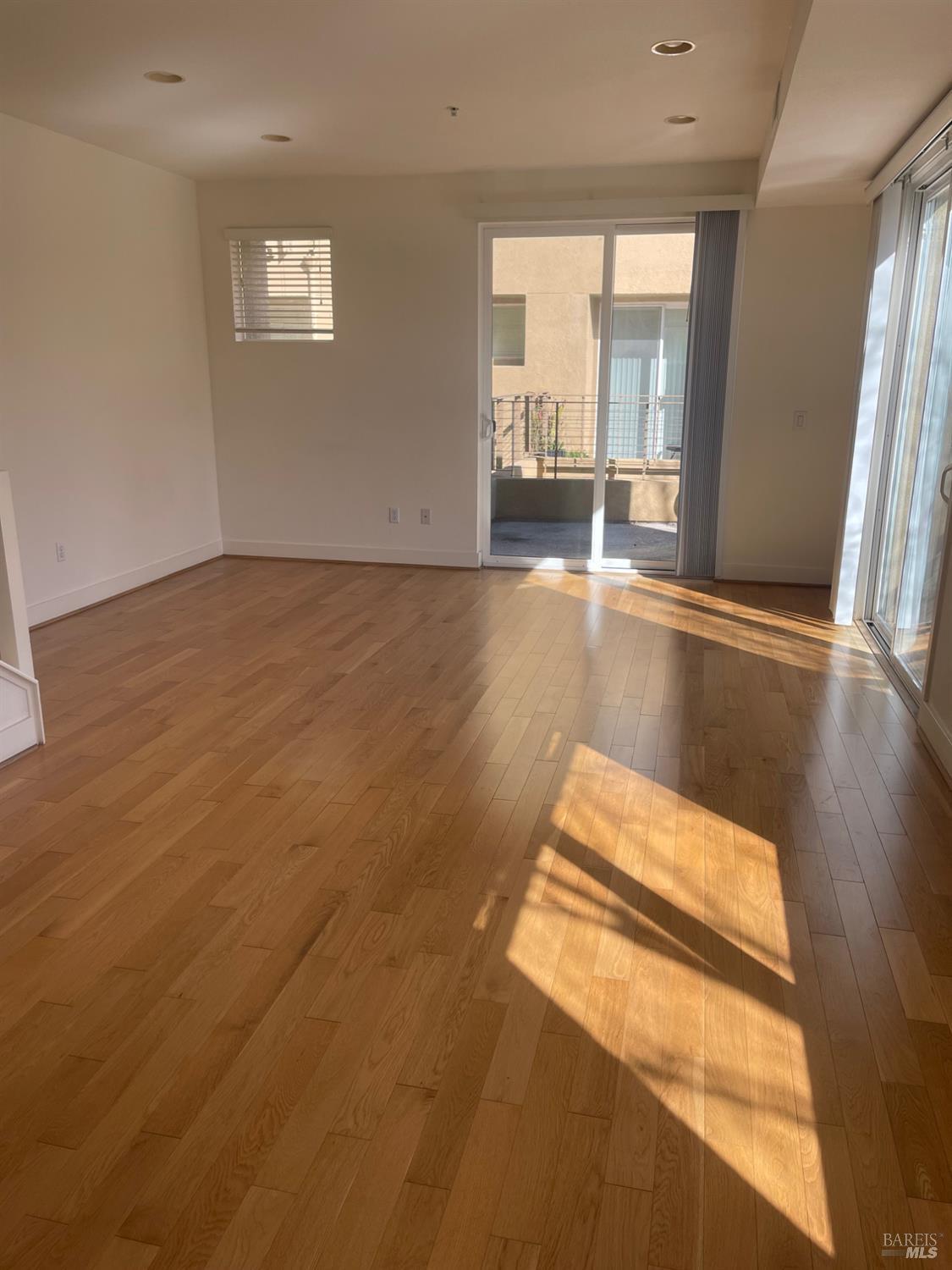 332 City Center Drive Rohnert Park, CA 94928 - Photo 5 of 10 an empty room with wooden floor and windows