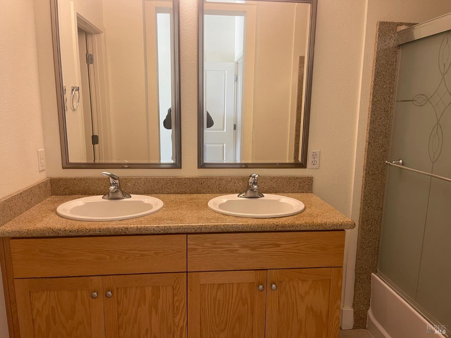 332 City Center Drive Rohnert Park, CA 94928 - Photo 8 of 10 a bathroom with two sink and a mirror