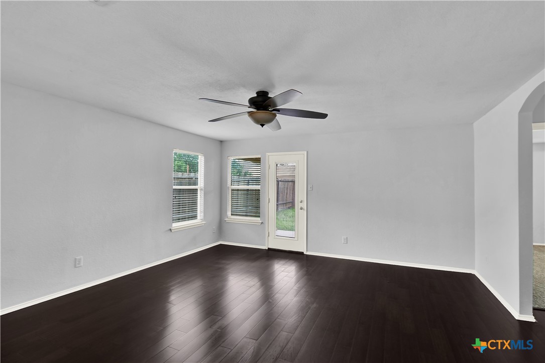 117 Bashaw Loop Temple, TX 76502 - Photo 13 of 20 a view of wooden floor and a chandelier fan in a room