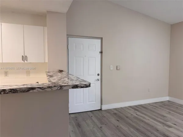 a kitchen with appliances a sink and cabinets