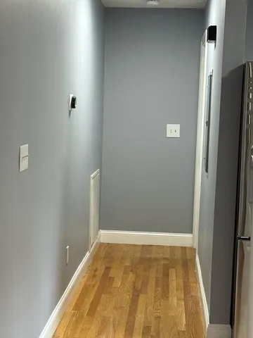 a view of a kitchen with wooden floor and staircase