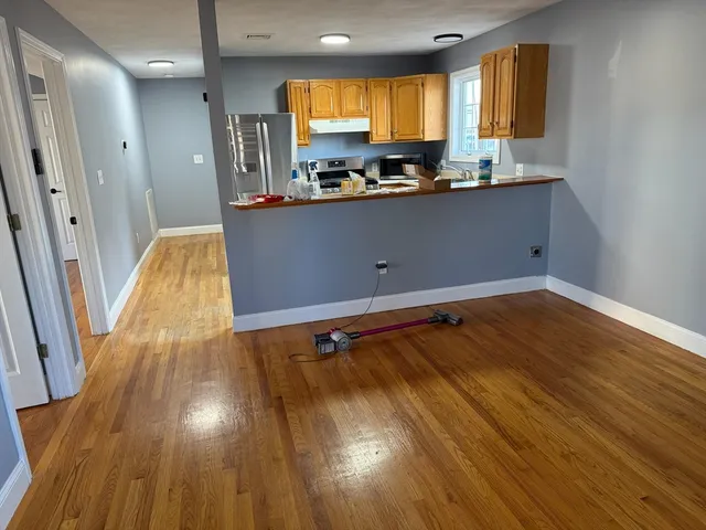 a view of an empty room and wooden floor