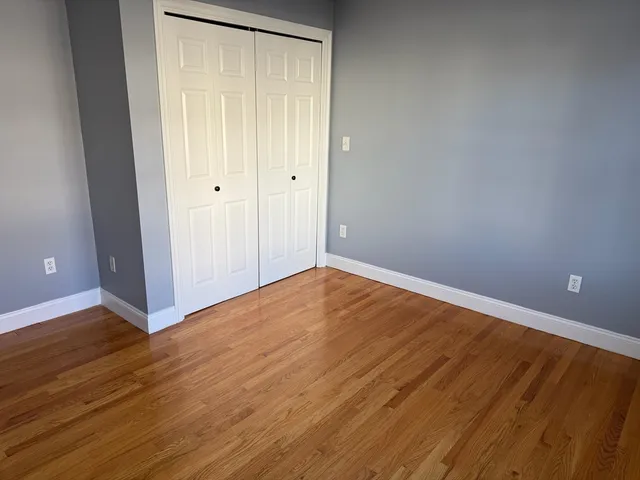 a kitchen with granite countertop a refrigerator and a sink