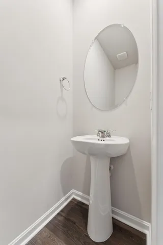 a bathroom with a sink toilet and mirror
