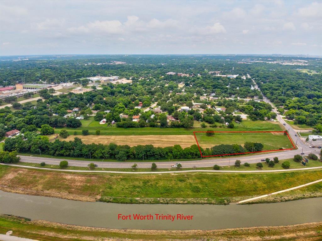 an aerial view of residential houses with outdoor space and lake view
