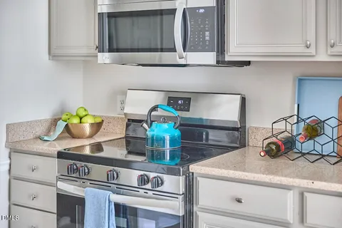 a kitchen with a stove and cabinets