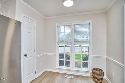 a view of a livingroom with wooden floor and a window